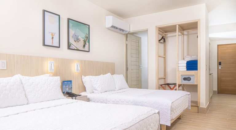 a bright and spacious hotel room with large beds